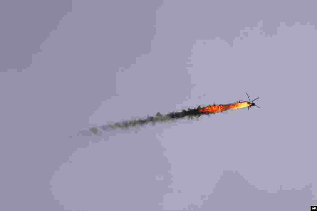 A Syrian government helicopter is downed by a missile in Idlib province.