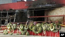 A makeshift memorial of funeral wreaths line the circular driveway of the Casino Royale in Monterrey, Mexico, August, 27, 2011.