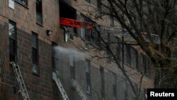 El personal de emergencia del Departamento de Bomberos de Nueva York responde al incendio de un edificio de apartamentos en el distrito del Bronx de la ciudad de Nueva York, EE. UU., el 9 de enero de 2022. 