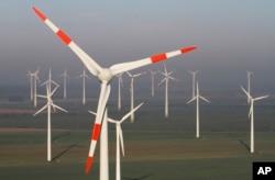 FILE - Wind turbines produce green energy in Nauen near Berlin, Germany, Oct. 12, 2012.