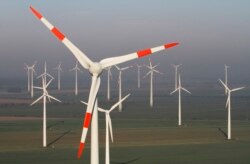 FILE - Wind turbines produce green energy in Nauen near Berlin, Germany, Oct. 12, 2012.