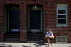 Jack Coopersmith sits outside his apartment and takes part in remote meeting while working from home amid the coronavirus disease (COVID-19) outbreak in Cambridge, Massachusetts,May 22, 2020.