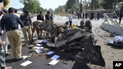 Pakistani police officers examine the site of an explosion in Quetta, Pakistan, June 23, 2017. A powerful bomb went off near the office of the provincial police chief in southwest Pakistan, causing casualties, police said.