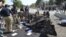 Pakistani police officers examine the site of an explosion in Quetta, Pakistan, June 23, 2017. A powerful bomb went off near the office of the provincial police chief in southwest Pakistan, causing casualties, police said.