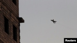 A Syrian Air Force jet is seen flying in the sky above Raqa province, eastern Syria, in this August 17, 2013, file photo.