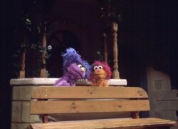 FILE - Israeli Muppet Daffy, left, visits Palestinian Muppet Haneen on the set of a Palestinian street during the taping of a joint Israeli-Palestinian production of "Sesame Street," April 1, 1997.