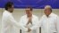 Lead FARC negotiator Ivan Marquez, left, and lead Colombian government negotiator Humberto de la Calle shake hands while Cuba's Foreign Minister Bruno Rodriguez looks on after the signing of a final peace deal in Havana, Cuba, Aug. 24, 2016.
