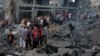 Palestinians inspect damage in the aftermath of Israeli strikes, following a Hamas surprise attack, at Beach refugee camp, in Gaza City, Oct. 9, 2023.