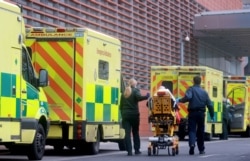 Medics transport a patient from an ambulance to the Royal London Hospital as the spread of the coronavirus disease continues in London, Britain, Jan. 1, 2021.