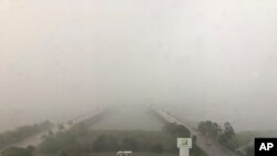 An initial swath of rain from Hurricane Dorian blankets downtown Charleston, S.C., on the morning of Wednesday, Sept. 4, 2019.