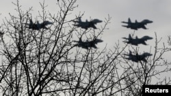 FILE - Russian Su-30 jet fighters fly in formation over Krasnoyarsk, Russia.