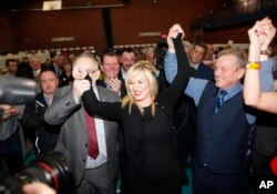 Sinn Fein's party leader for Northern Ireland Michelle O'Neill celebrates with party members Francie Molloy (left) and Ian Milne (right) after topping the poll in Mid Ulster, Ballymena count centre, Northern Ireland, March 3, 2017.