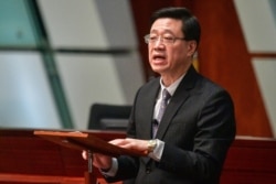 FILE - Hong Kong Secretary for Security John Lee speaks at the Legislative Council complex in Hong Kong, Oct. 23, 2019.