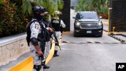 Government forces guard the entrance of hotel after an armed confrontation near Puerto Morelos, Mexico, Nov. 4, 2021. Two suspected drug dealers were killed.