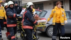 A wounded person is carried on a stretcher to an ambulance by firefighters and medics, after an explosion at the entrance of the U.S. Embassy in Ankara February 1, 2013. A suicide bomber killed a Turkish security guard at the U.S. embassy in Ankara on Fri