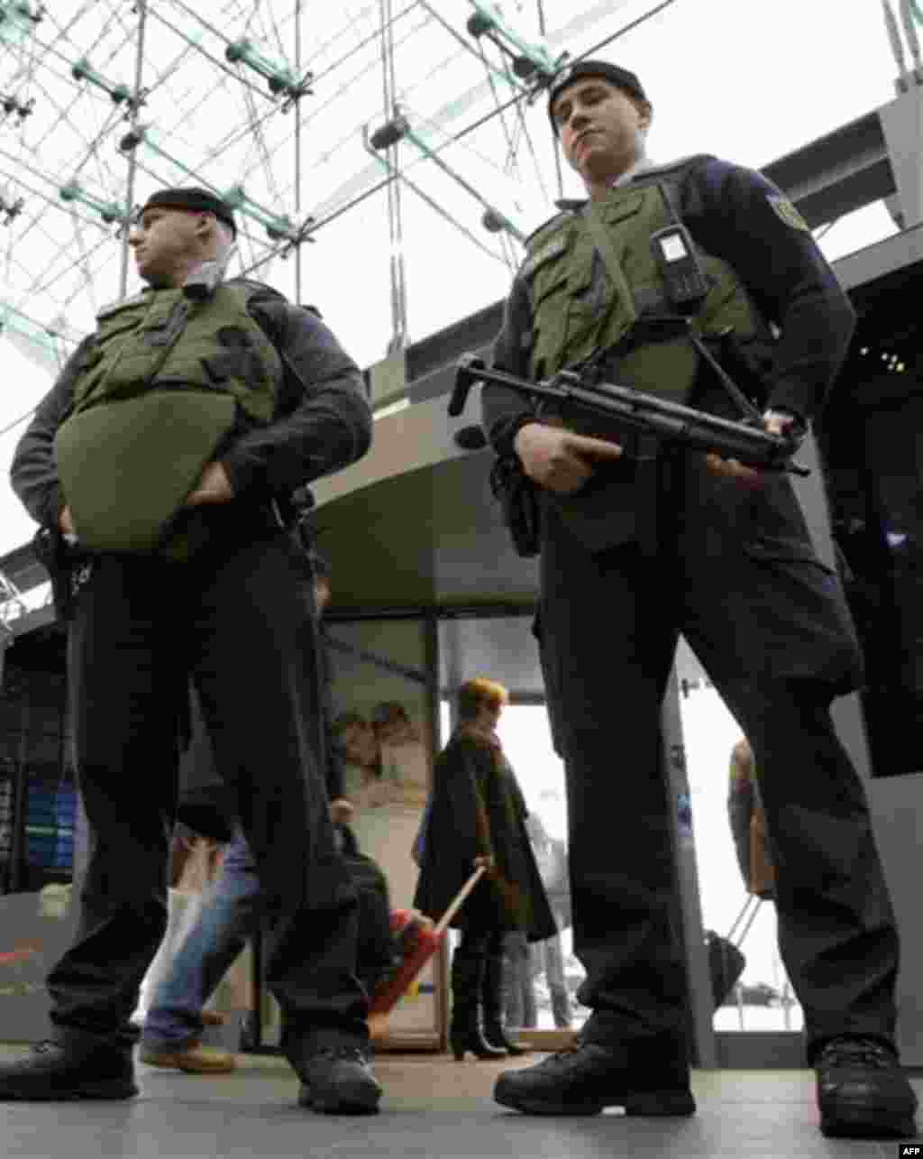 Armed police officers who are wearing bulletproof vests stand guard at the main train station in Berlin, Germany, Wednesday, Nov. 17, 2010. German Interior Minister Thomas de Maiziere announced on Wednesday, increased security in the country in light of a