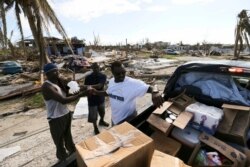 Volunteers hand out food and water to the survivors of Hurricane Dorian in Marsh Harbor, Abaco Island, Bahamas, Sept. 6, 2019. The Bahamian health ministry said helicopters and boats are on the way to help people in affected areas.