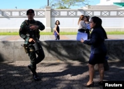 Philippine security personnel patrol near U.S Visa applicants after an Improvised Explosive Device (IED) was found near the US Embassy in Manila, Philippines November 28, 2016.