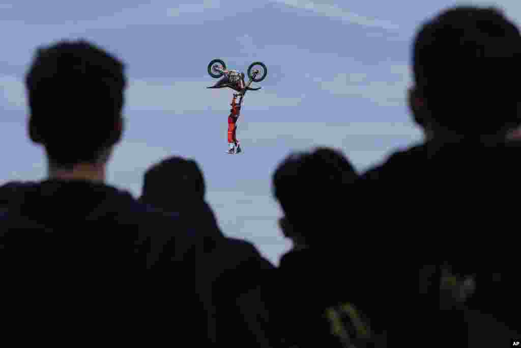 Riders perform during a freestyle motocross show at the EICMA exhibition motorcycle fair in Rho, outskirt of Milan, Italy.