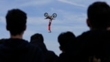 Riders perform during a freestyle motocross show at the EICMA exhibition motorcycle fair in Rho, outskirt of Milan, Italy, Nov. 7, 2024. 