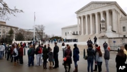 People stand in line to enter the Supreme Court, March 28, 2018, in Washington, where the court heard arguments on a gerrymandering case. The justices heard arguments in an appeal filed by Republicans in Maryland.