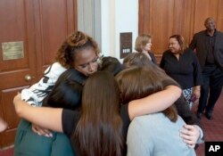 This image taken from video shows singer Jennifer Hudson embracing student journalists from Marjory Stoneman Douglas High School in Parkland, Fla., who were recognized at the 2019 Pulitzer Prize winners awards luncheon at Columbia University in New York, May 28, 2019.