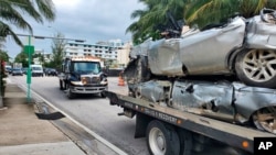 Vehicles that were pulled from the rubble of the Champlain Towers South are transported on Saturday, July 10, 2021 in Surfside, Fla. Surfside Mayor Charles Burkett said crews were making good progress, especially in clearing debris from the section…