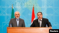 FILE- Iran's Foreign Minister Mohammed Javad Zarif (L) speaks during a joint news conference with Iraq's Foreign Minister Hoshyar Zebari (R) in Baghdad, Jan. 14, 2014