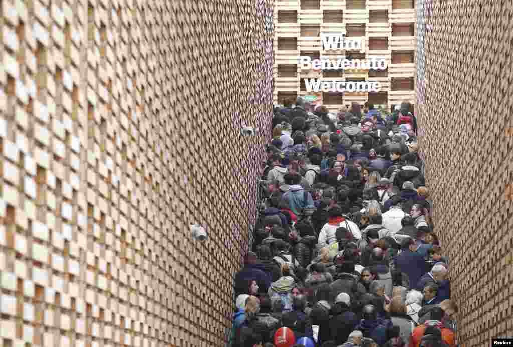 Visitors queue outside the Poland pavilion at the Expo 2015 global fair in Milan, Italy.