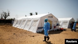 Medical staff wear protective masks at a cholera treatment center set up in the aftermath of Cyclone Idai in Beira, Mozambique, March 29, 2019. 