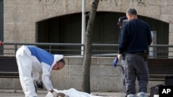 Israeli policemen inspect the body of an alleged Palestinian assailant in Jerusalem, Dec. 26, 2015. 