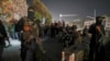 Security forces of the new Syrian government secure the area around group of Alawite protesters in the Mazzeh district of Damascus on Dec. 25, 2024. The minority Alawite community is an offshoot of Shiite Islam to which former President Bashar al-Assad belongs.