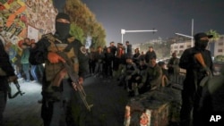 Security forces of the new Syrian government secure the area around group of Alawite protesters in the Mazzeh district of Damascus on Dec. 25, 2024. The minority Alawite community is an offshoot of Shiite Islam to which former President Bashar al-Assad belongs.