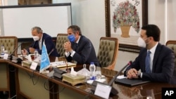 Rafael Mariano Grossi, Director General of International Atomic Energy Agency, IAEA, center, attends a meeting with the Head of Atomic Energy Organization of Iran, Mohammad Eslami, in Tehran, Iran, Sept. 12, 2021.