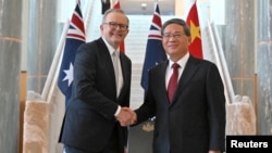 Chinese Premier Li Qiang shakes hands with Australia’s Prime Minister Anthony Albanese at the Australian Parliament House in Canberra, Australia, June 17, 2024.