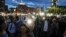 People flash the lights of their mobile phones during a protest outside the government headquarters in Bucharest, Romania, May 12, 2018. Thousands gathered to demonstrate against a judicial overhaul they say will make it harder to prosecute senior officials for graft.