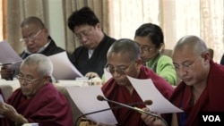 Para anggota parlemen Tibet membaca pesan tertulis dari Dalai Lama dalam sesi parlemen di Dharmsala, Senin (14/3).