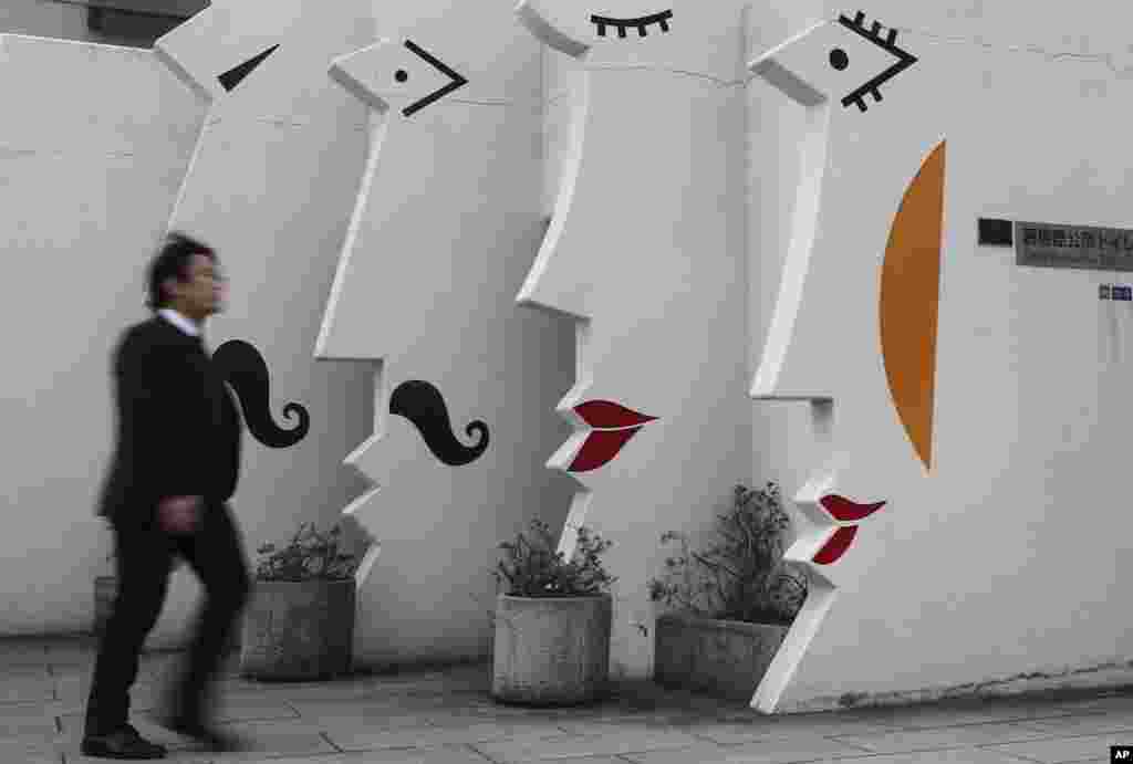 A man walks past a public restroom at Tokyo, Japan.