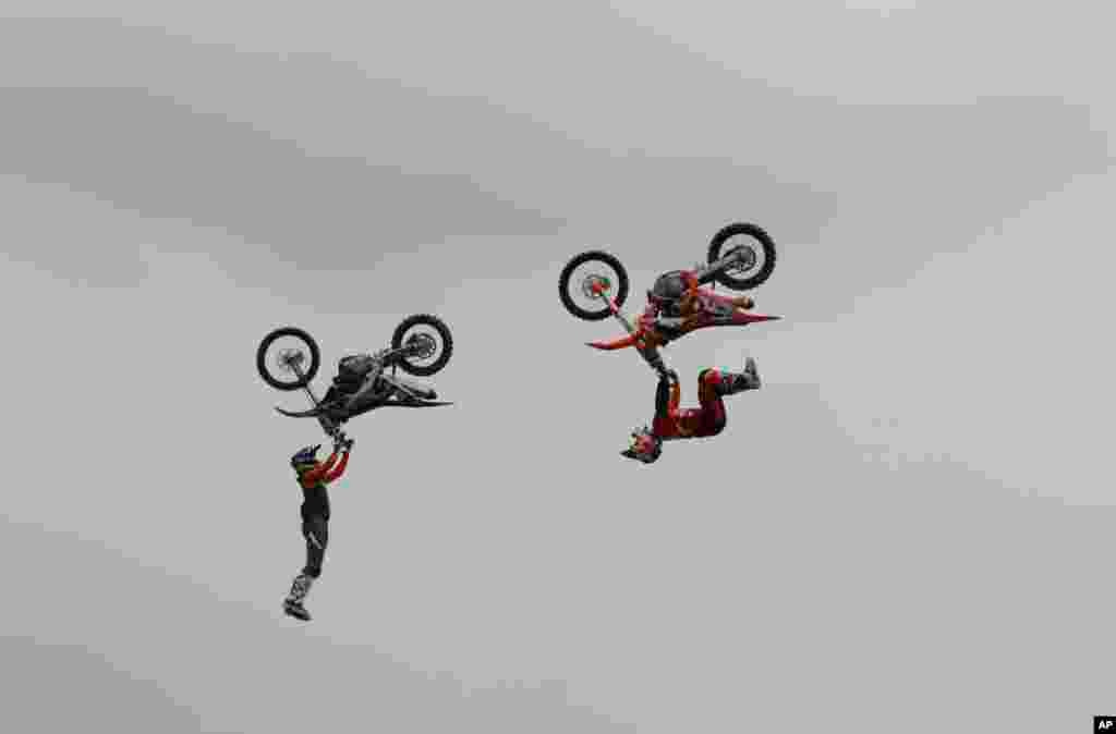 Riders perform during a freestyle motocross show at the EICMA exhibition motorcycle fair in Milan, Italy.