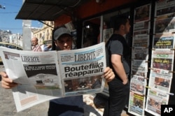 FILE - The local newspaper Liberte is among the publications seen at a newstand in Algiers, Algeria, June 13, 2013.