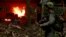  A Colombian anti-narcotics policeman stands guard after burning a cocaine lab, which police said belongs to criminal gangs, in a rural area of Colombia, August 2, 2016. Colombia, one of the world's top cocaine producers, sold $2 billion in illegal drugs inside its own borders last year.  