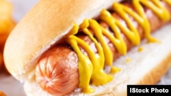 A hotdog with mustard