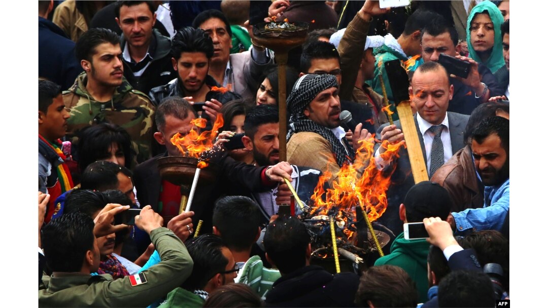 Syrian Kurds light torches as they celebrate the Nowruz spring festival in the capital Damascus, March 21, 2015.