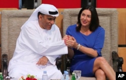 FILE - In this Oct. 27, 2018 photo, Israeli Culture and Sport Minister Miri Regev shakes hands with Mohamed Bin Tha'loob Al Derai, President of UAE Wrestling Judo & Kickboxing Federation, after an Israeli athlete won the bronze medal during a tournament hosted by UAE.