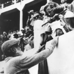 Ernest Hemingway talks with actress Lauren Bacall at a bullring in Dax, France