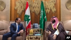 FILE - Saudi Crown Prince Mohammed bin Salman, right, meets with Lebanese Prime Minister Saad Hariri in Riyadh, Saudi Arabia, Oct. 30, 2017.