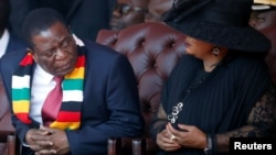 Zimbabwean President Emmerson Mnangagwa looks on next to his wife Auxillia Mnangagwa during the state funeral of the country's founder and longtime ruler Robert Mugabe