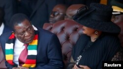 Zimbabwean President Emmerson Mnangagwa looks on next to his wife Auxillia Mnangagwa during the state funeral of the country's founder and longtime ruler Robert Mugabe
