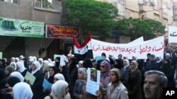 In this citizen journalism image made on a mobile phone, Syrian women carry a banner in Arabic that reads:' the women of Darayya want an end to the siege,' as they protest in Darayya, southwest of Damascus, Syria, April 25, 2011