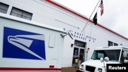 FILE - The entrance of a United States Post Office is seen in Manhasset, New York.